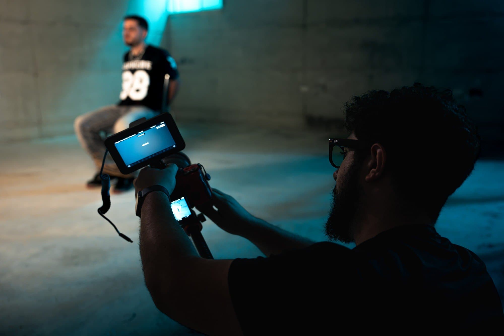 Amit Shiber on set, framing a shot on the camera's monitor